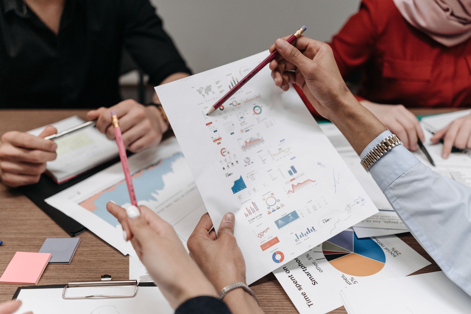Team reviewing business reports and charts during a collaborative meeting